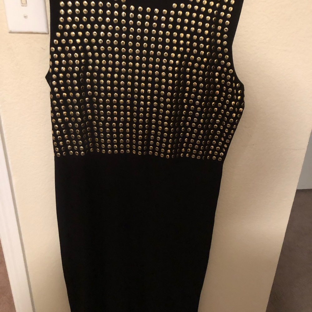 Black dress with gold studs in the front.